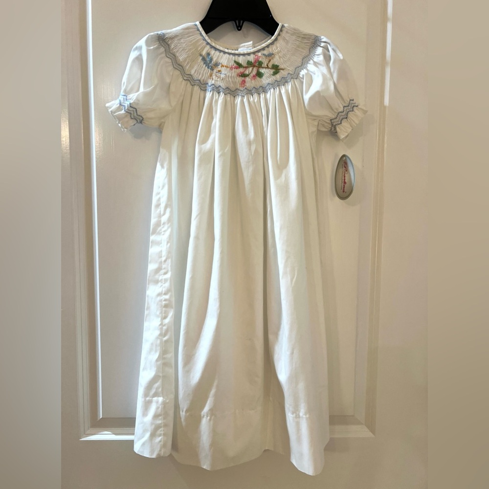 White Smocked Girls' Dress with Blue Trim and Floral Embroidery